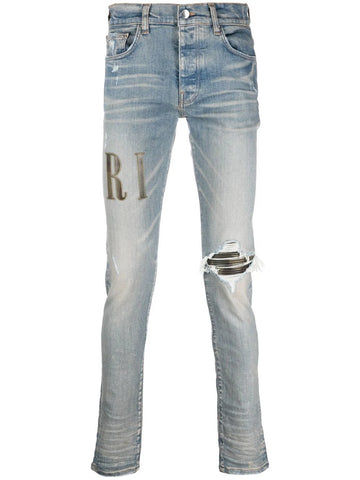 AMIRI logo-print distressed skinny jeans